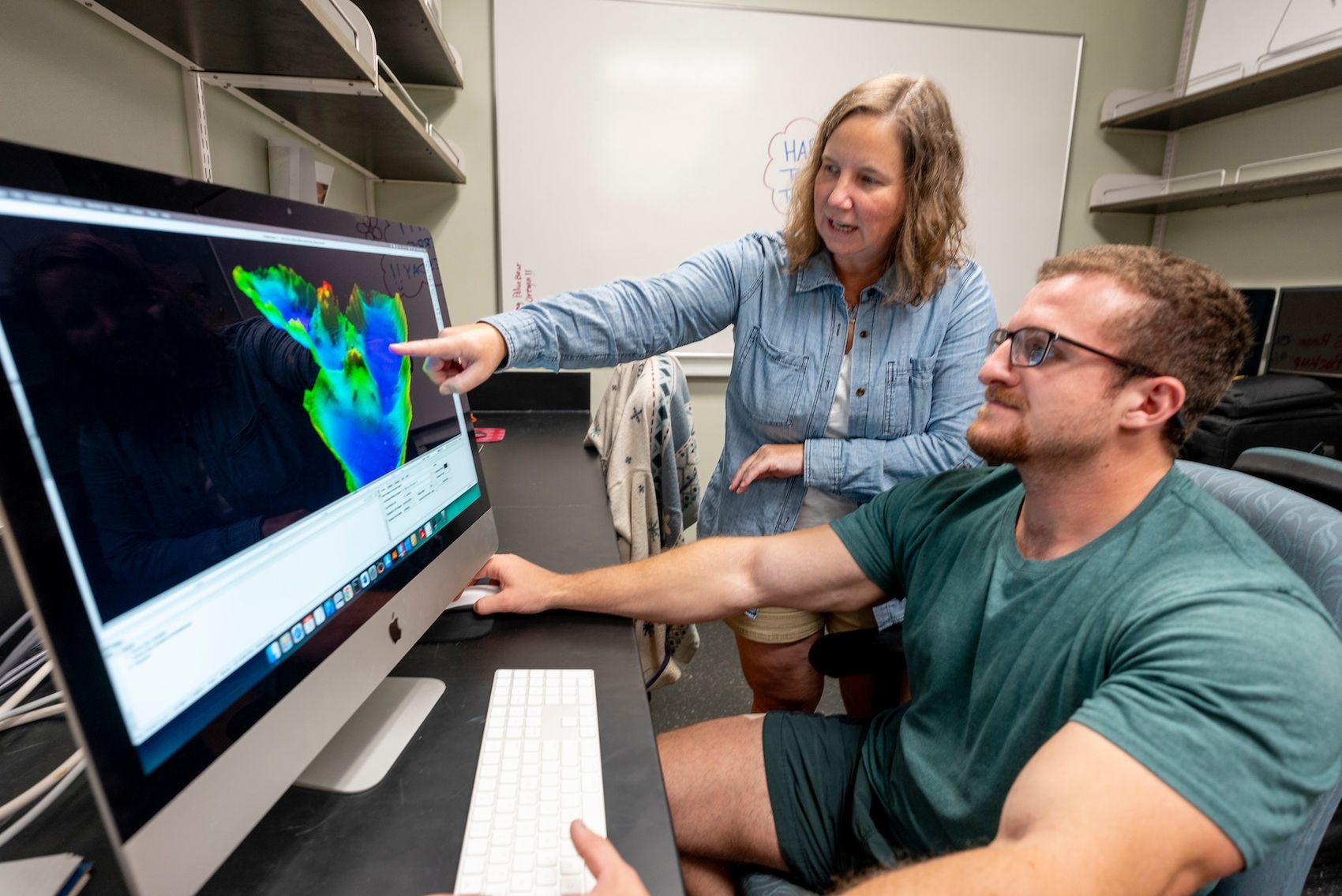 Doctoral student Chris Blanco and Andrea Hawkes, professor of earth and ocean sciences, inspect core samples from Camel Cove, Atka Island, Alaska.  